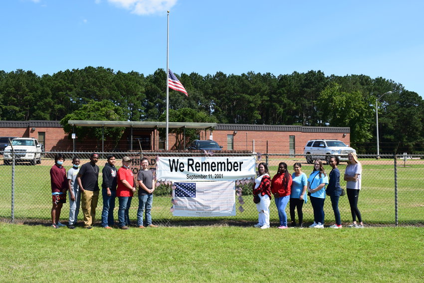 Philadelphia/Neshoba County Career Technical Center Law and Public Safety students who put up 9/11 banners to display outside the facility are, from left, Cali Wilson, Jonathan Medford, Kendall Hoskins, JonPaul Moore, Danny Hughes, Kayden Gray, Posey Palmer, Jada Greer, Cameron Burnham, Mia Johnson, India Sanders, Allison Alford.
